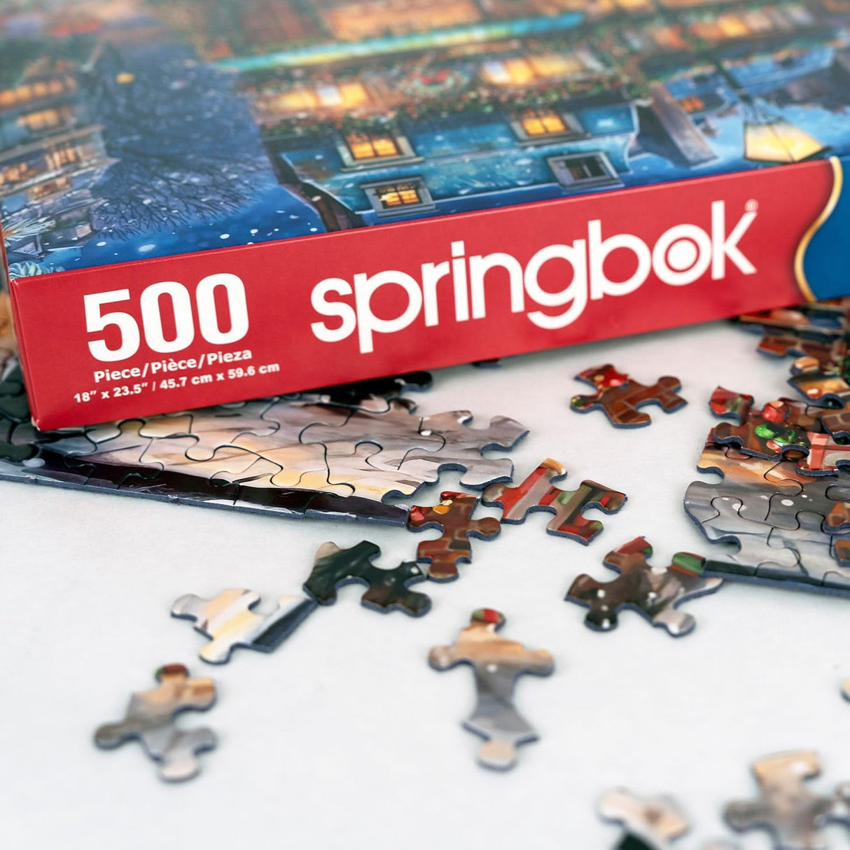 Springbok's Winter Wonderland Cafe 500 Piece Jigsaw Puzzle is a Picturesque Holiday Scene of a Cosy Cafe in The City